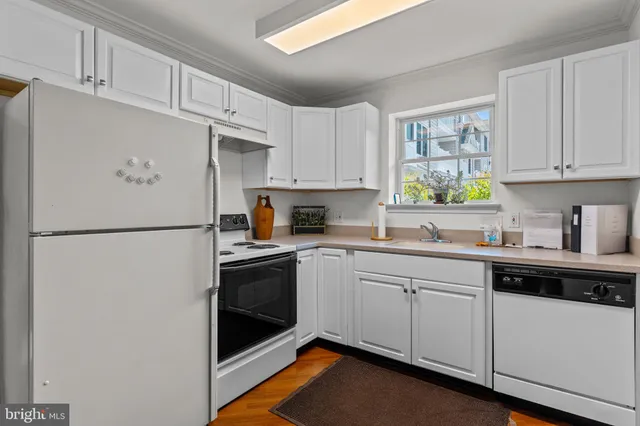 a kitchen with stainless steel appliances granite countertop a refrigerator sink and stove