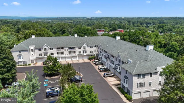 an aerial view of multiple houses with a yard