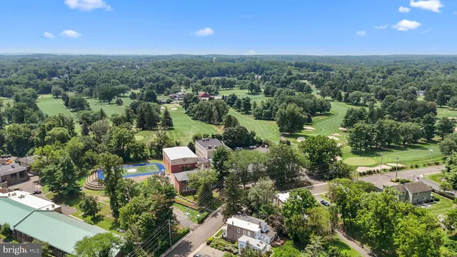 an aerial view of a city with lots of residential buildings and mountain view in back