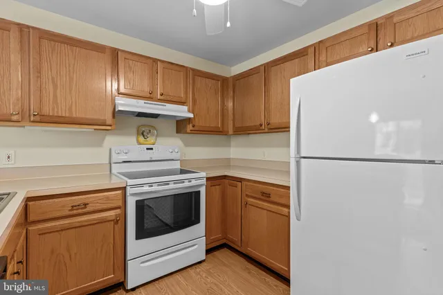a kitchen with stainless steel appliances granite countertop a refrigerator a stove a sink and a microwave