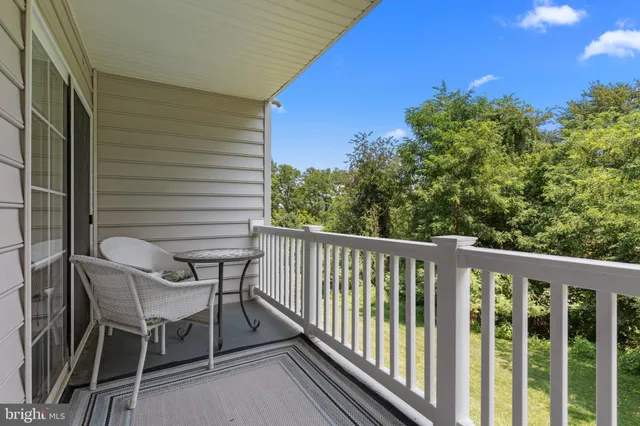 a view of a chairs and table in the balcony