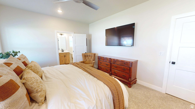 1127 4240 North Enoch, UT 84721 - Photo 19 of 56 Master Bedroom with light colored carpet, ensuite bath, and a ceiling fan