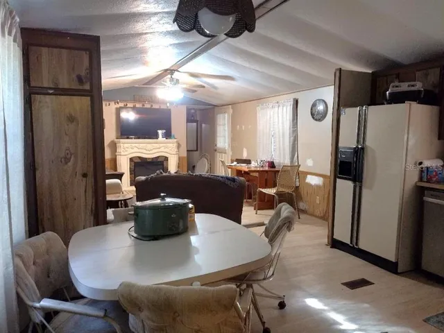 a dining room with furniture a window and kitchen view