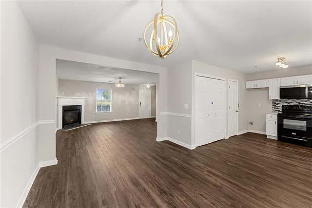 a view of empty room with wooden floor and fireplace