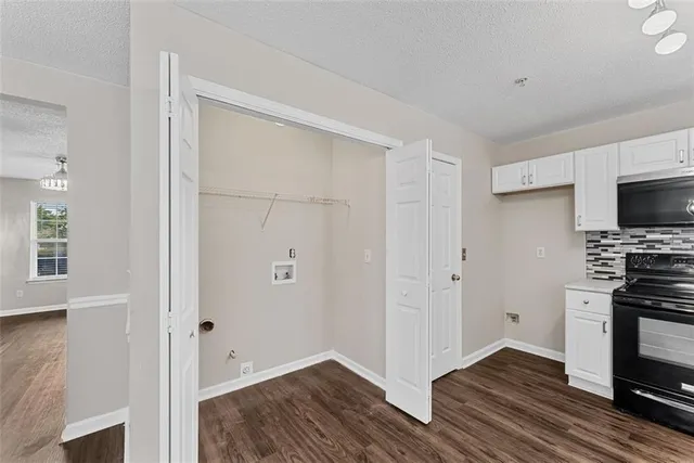 a view of kitchen with wooden floor and electronic appliances