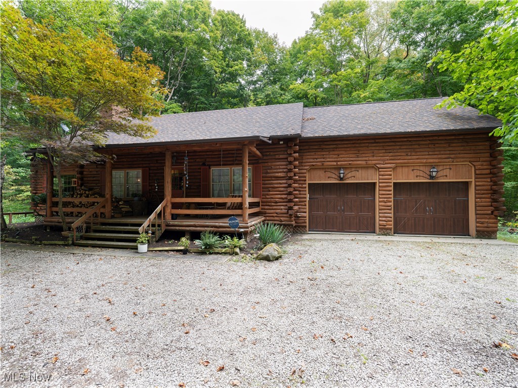 16535 Messenger Road Chagrin Falls, OH 44023 - Photo 1 of 37 Log cabin with an attached 2 car garage and a covered porch