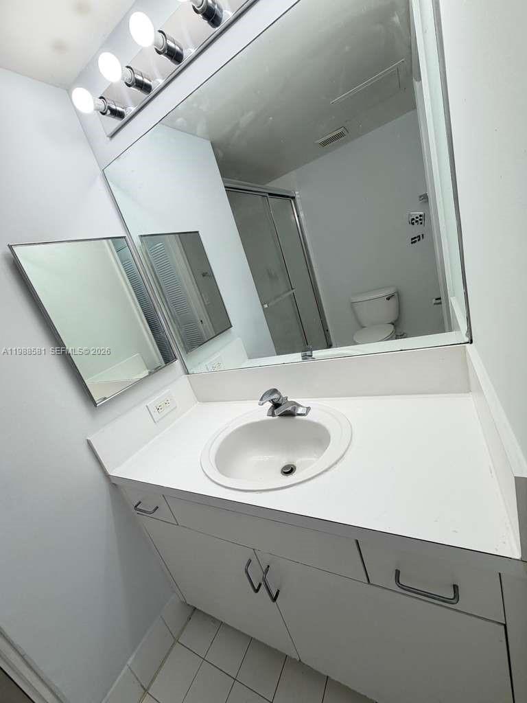 2173 Renaissance Boulevard, Unit 101 Miramar, FL 33025 - Photo 15 of 27 a bathroom with a sink and a mirror