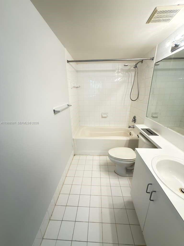 2173 Renaissance Boulevard, Unit 101 Miramar, FL 33025 - Photo 19 of 27 a bathroom with a sink a toilet and shower