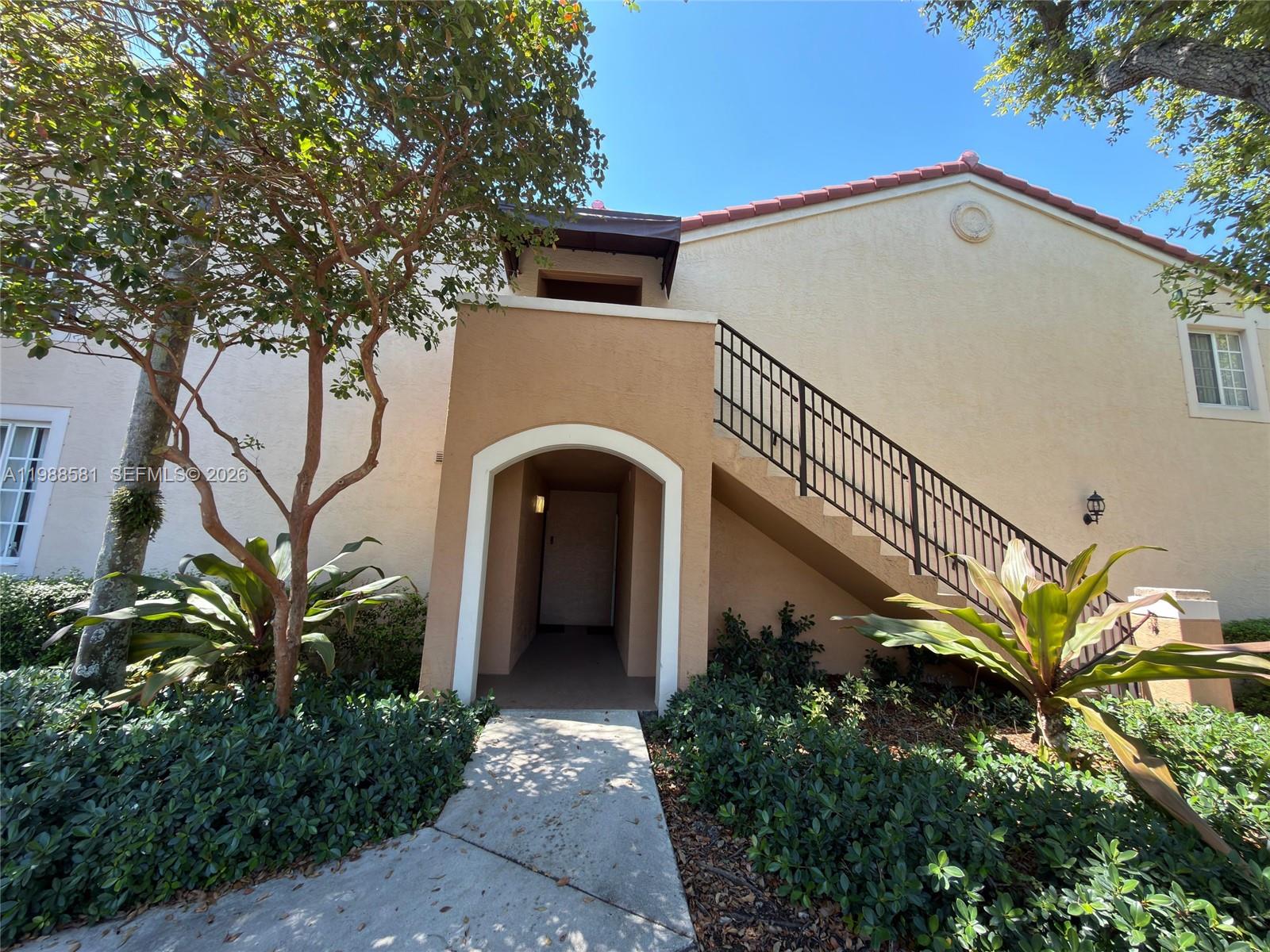 2173 Renaissance Boulevard, Unit 101 Miramar, FL 33025 - Photo 2 of 27 a front view of a house with garden