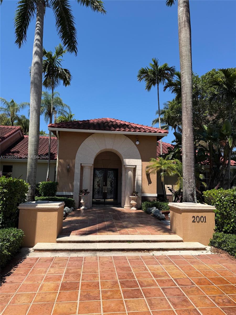 2173 Renaissance Boulevard, Unit 101 Miramar, FL 33025 - Photo 21 of 27 a view of a building with a pathway and a potted plants