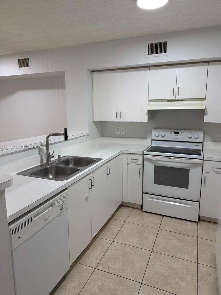 2173 Renaissance Boulevard, Unit 101 Miramar, FL 33025 - Photo 8 of 27 a kitchen with cabinets appliances and a sink