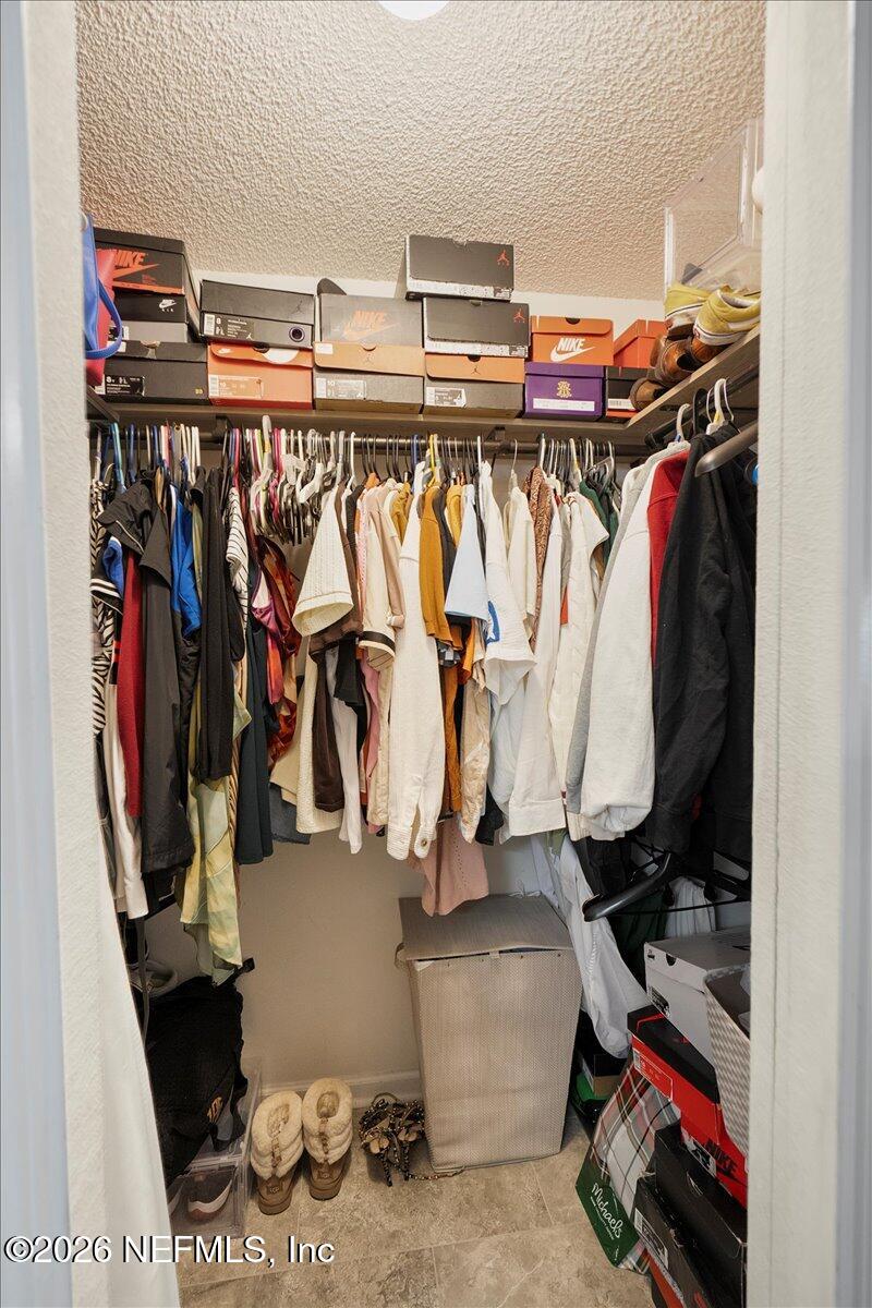 10310 Woodley Point Road Jacksonville, FL 32218 - Photo 20 of 30 a view of walk in closet with clothes and shoes