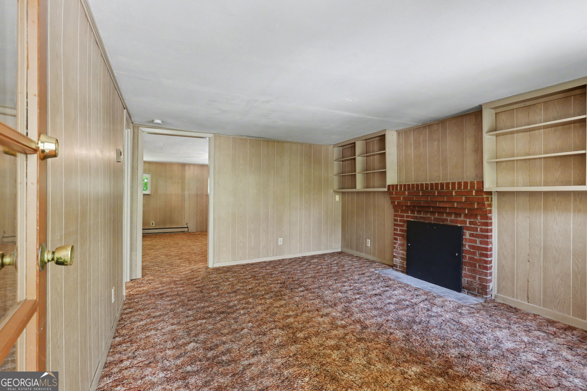 138 Taylors Chapel Road Rabun Gap, GA 30568 - Photo 12 of 52 a view of an empty room with a fireplace and a window