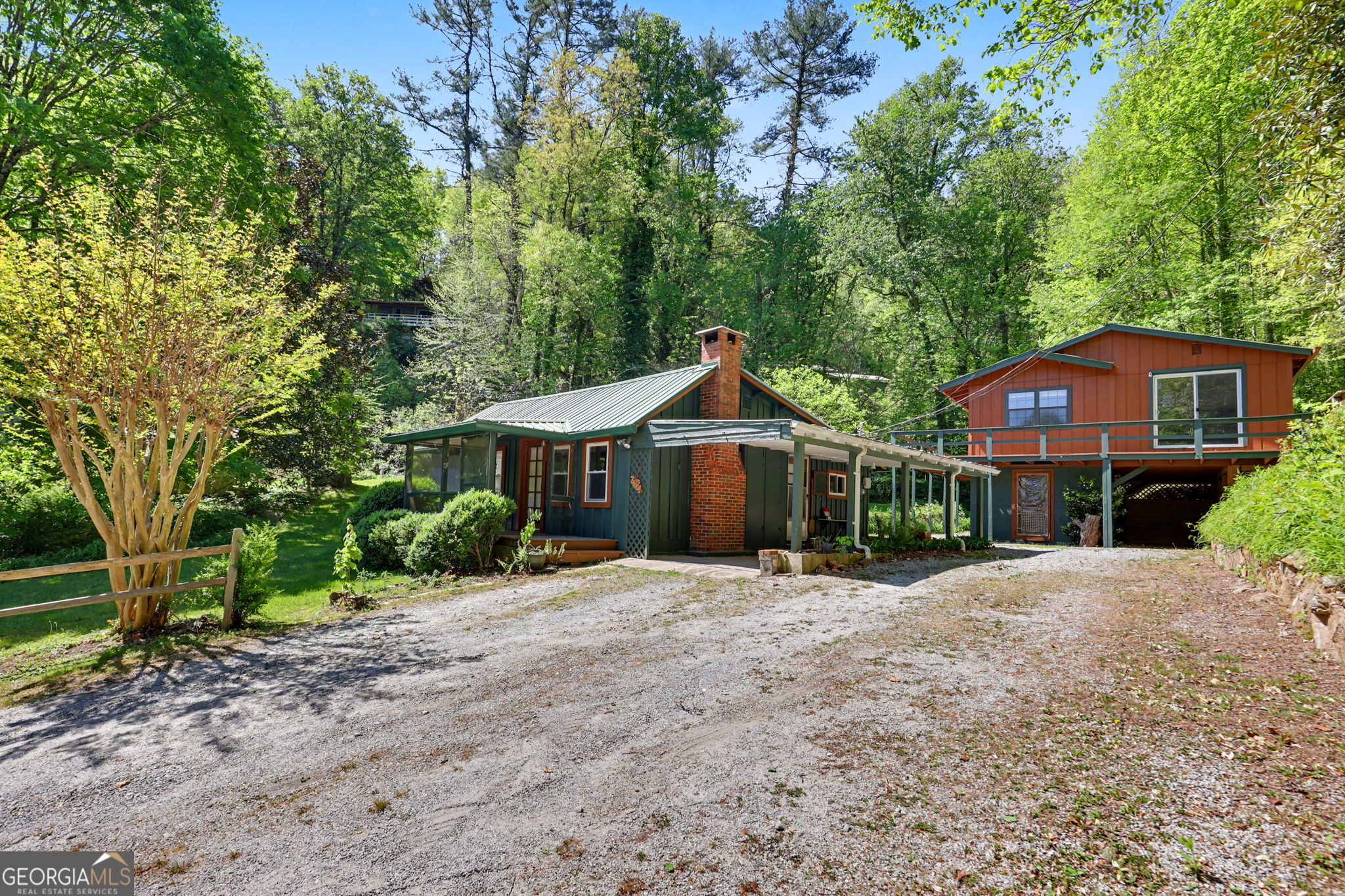 138 Taylors Chapel Road Rabun Gap, GA 30568 - Photo 2 of 52 a front view of a house with a garden