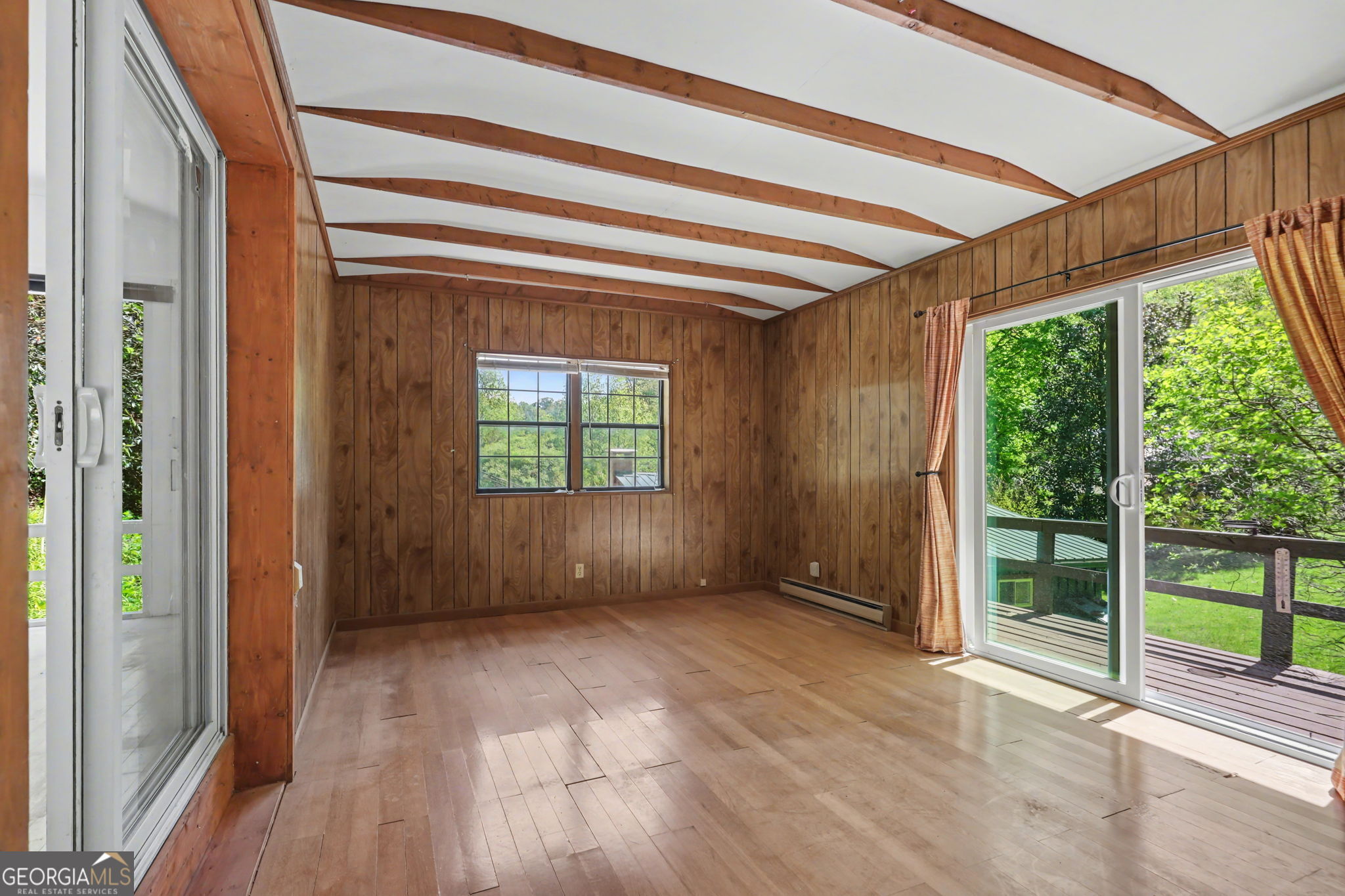 138 Taylors Chapel Road Rabun Gap, GA 30568 - Photo 26 of 52 a view of an empty room with wooden floor and a window