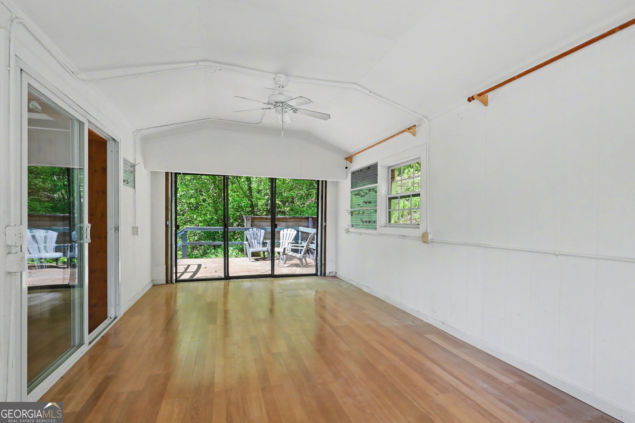 138 Taylors Chapel Road Rabun Gap, GA 30568 - Photo 30 of 52 a view of an empty room with wooden floor and a window