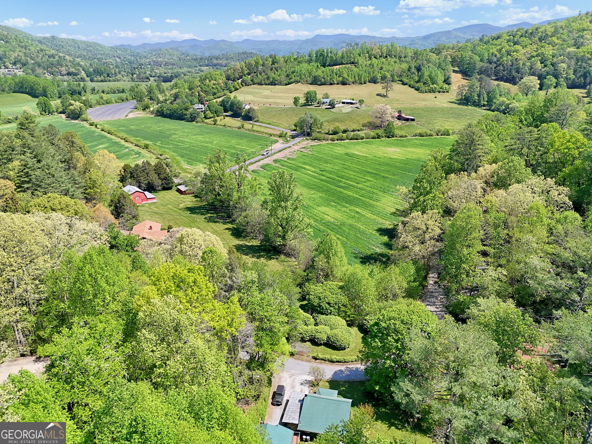 138 Taylors Chapel Road Rabun Gap, GA 30568 - Photo 50 of 52 an aerial view of green landscape with trees houses and a yard