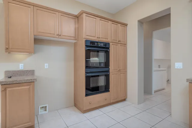 a kitchen with granite countertop white cabinets and stainless steel appliances
