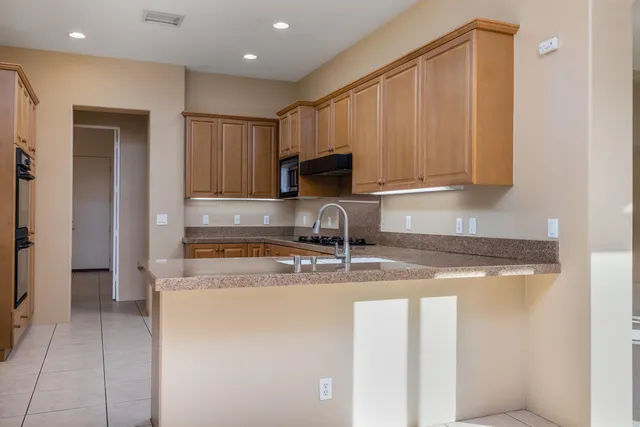 a kitchen with a sink a stove and a refrigerator