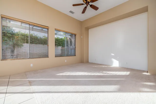 a view of room with window and a ceiling fan