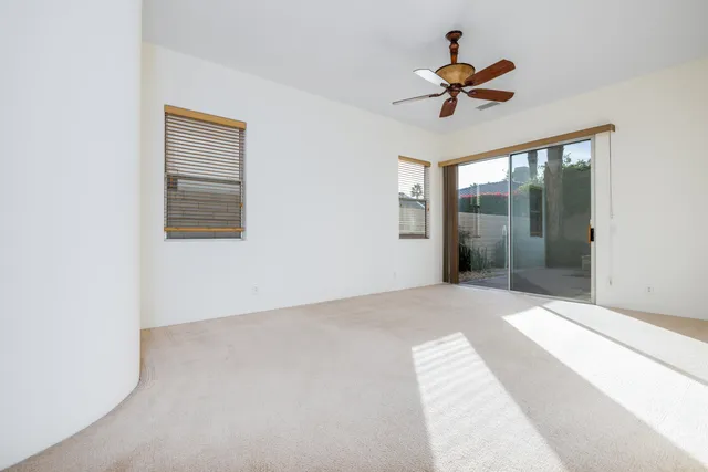 a spacious bathroom with a tub sink and mirror