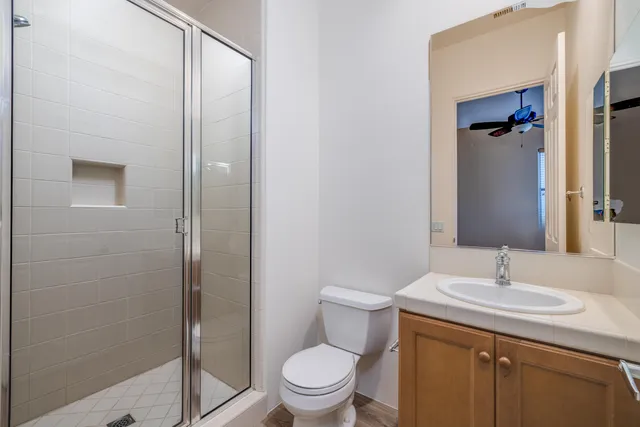 an empty room with a window and a fan