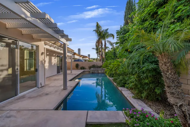 a view of a house with backyard and porch