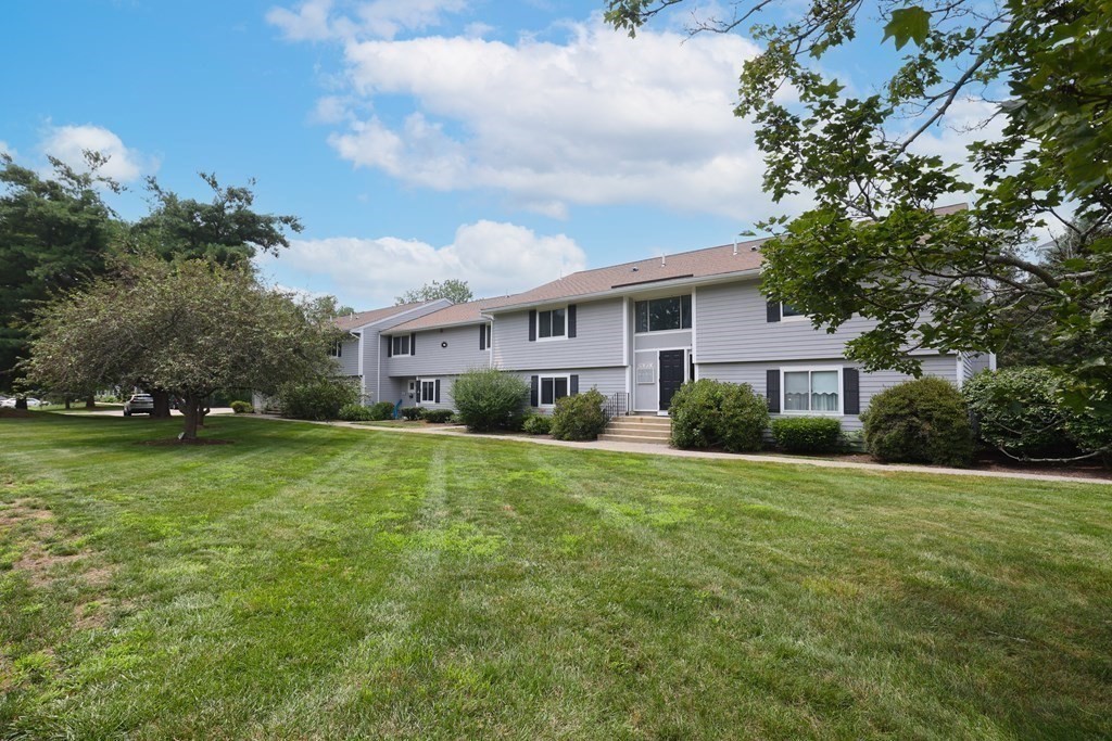 19 Beal's Cove Road, Unit K Hingham, MA 02043 - Photo 12 of 14 a view of a house with a big yard plants and large trees