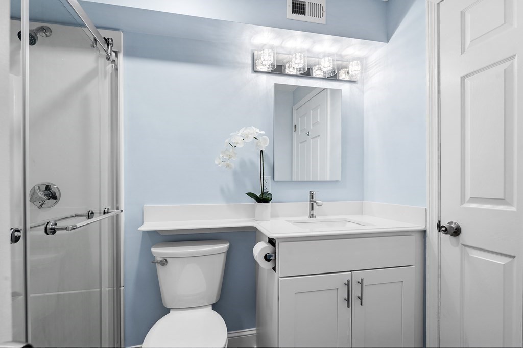 19 Beal's Cove Road, Unit K Hingham, MA 02043 - Photo 7 of 14 a bathroom with a sink a toilet and shower