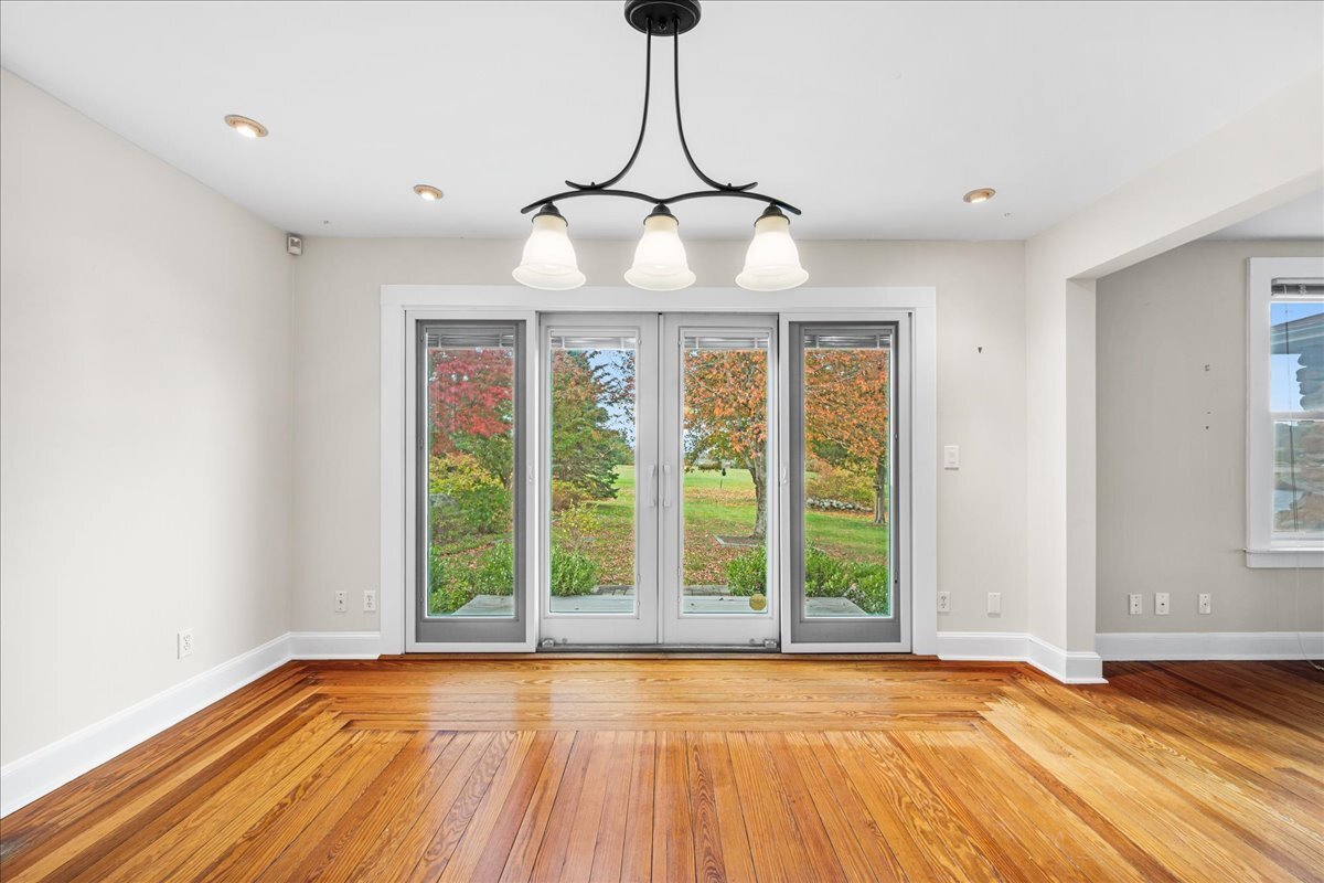 28 Palmer Neck Road Pawcatuck, CT 06379 - Photo 12 of 36 a view of an empty room with wooden floor and a window
