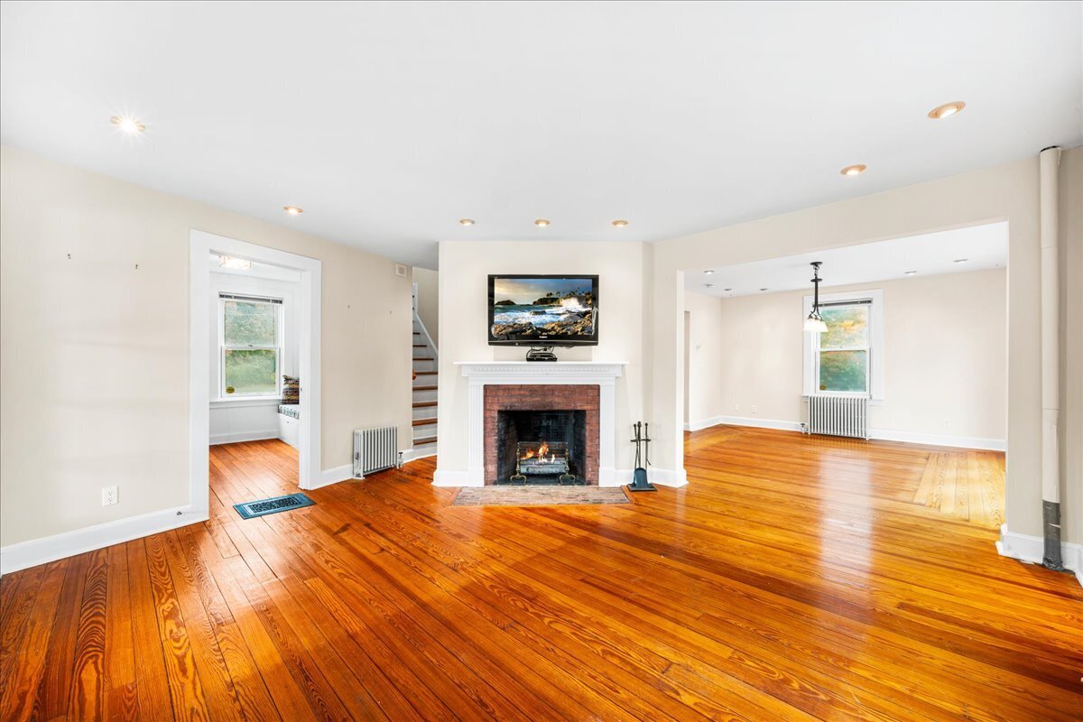 28 Palmer Neck Road Pawcatuck, CT 06379 - Photo 15 of 36 a view of an empty room with wooden floor fireplace and a window
