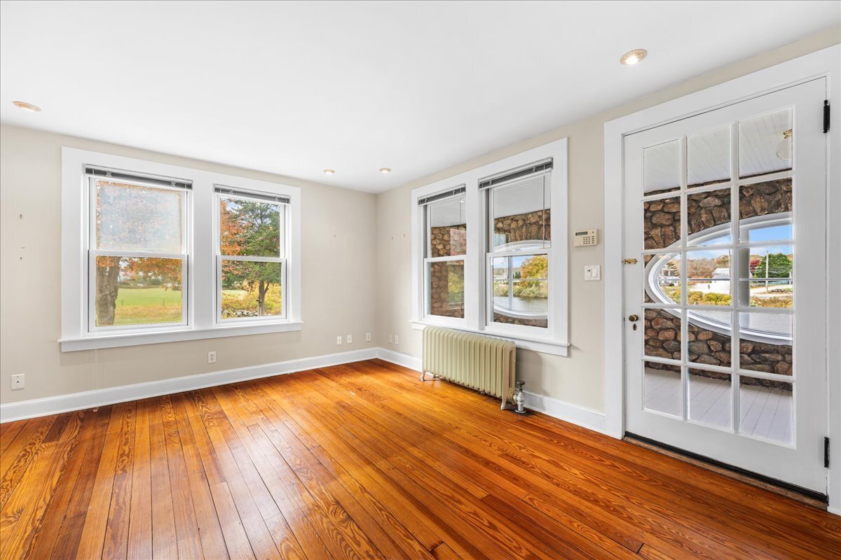 28 Palmer Neck Road Pawcatuck, CT 06379 - Photo 16 of 36 an empty room with wooden floor and windows