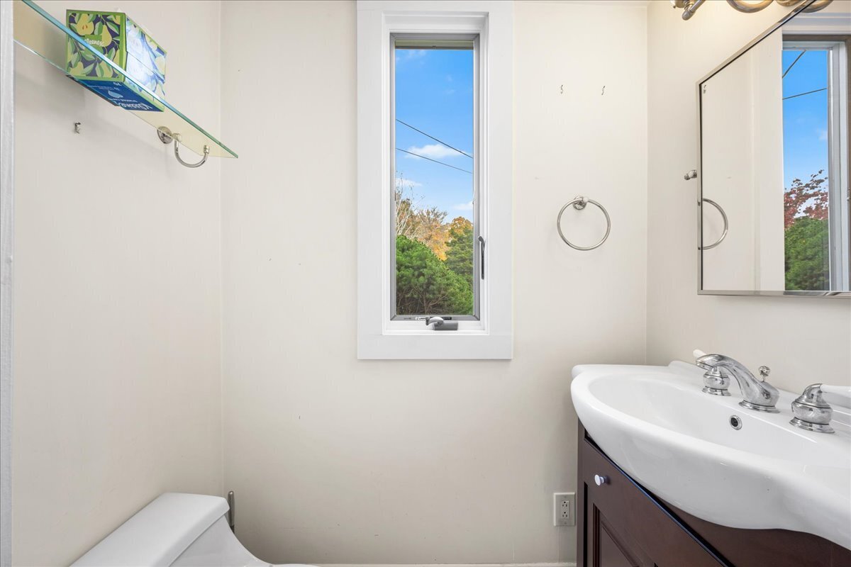 28 Palmer Neck Road Pawcatuck, CT 06379 - Photo 22 of 36 a bathroom with a sink mirror and toilet