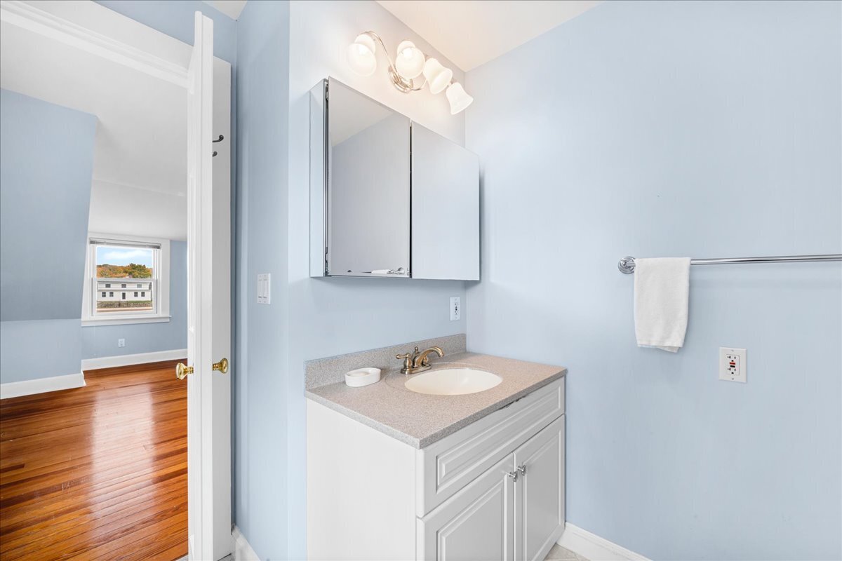 28 Palmer Neck Road Pawcatuck, CT 06379 - Photo 28 of 36 a bathroom with a sink a mirror and vanity