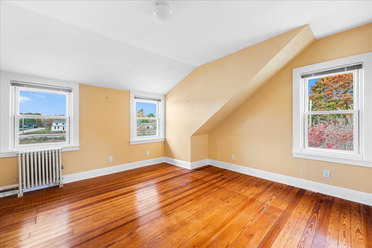 28 Palmer Neck Road Pawcatuck, CT 06379 - Photo 29 of 36 a view of an empty room with wooden floor and a window