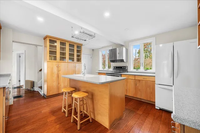 a kitchen with granite countertop appliances a sink and a refrigerator