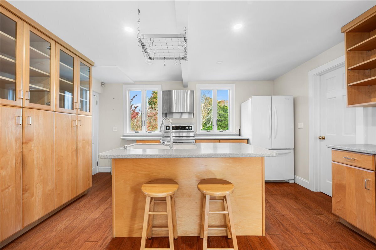 28 Palmer Neck Road Pawcatuck, CT 06379 - Photo 9 of 36 a kitchen with stainless steel appliances granite countertop a dining table chairs refrigerator and sink
