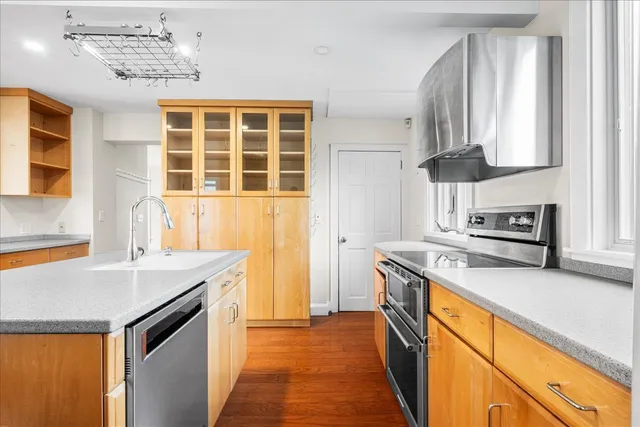 a kitchen with stainless steel appliances a sink a stove and a refrigerator