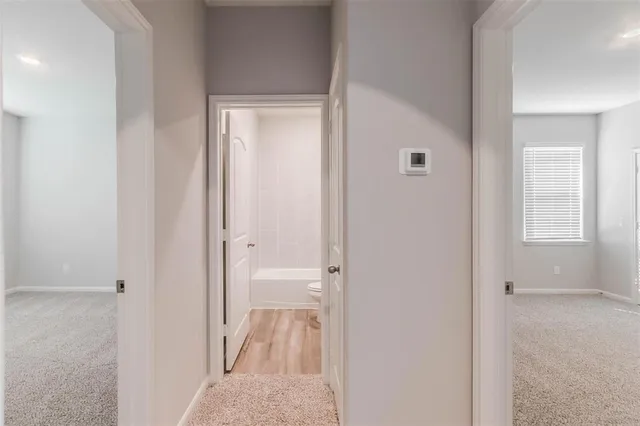 a view of a bathroom from the hallway