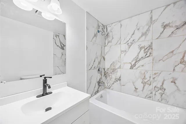 a bathroom with a bathtub and shower