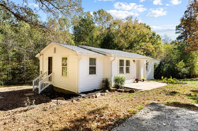 a front view of a house with a yard covered in snow