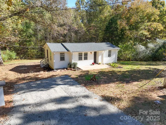 a view of a yard with wooden fence