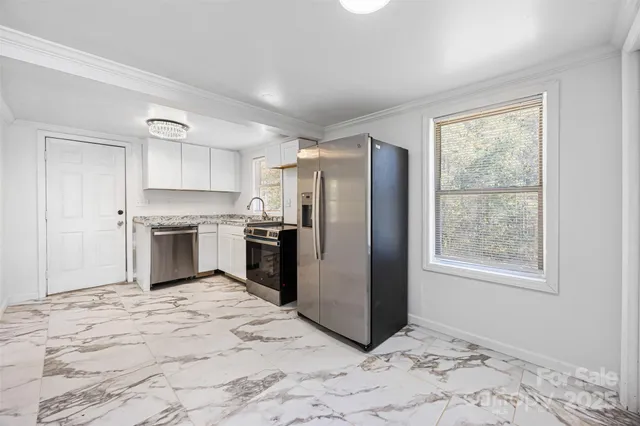 a kitchen with stainless steel appliances granite countertop a refrigerator sink and cabinets