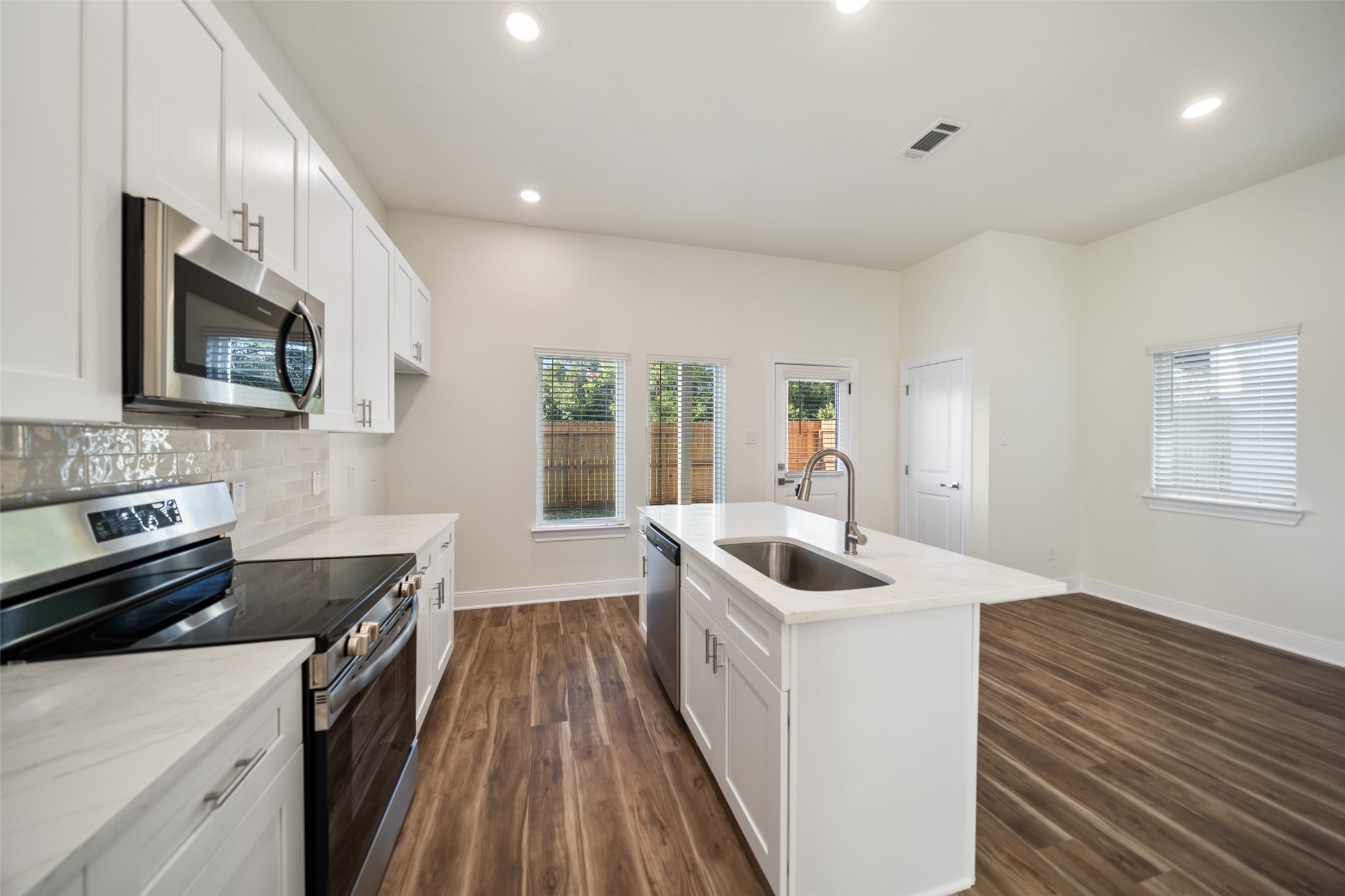 412 West Marlin Street Willis, TX 77378 - Photo 7 of 22 a kitchen that has a sink and a stove top oven