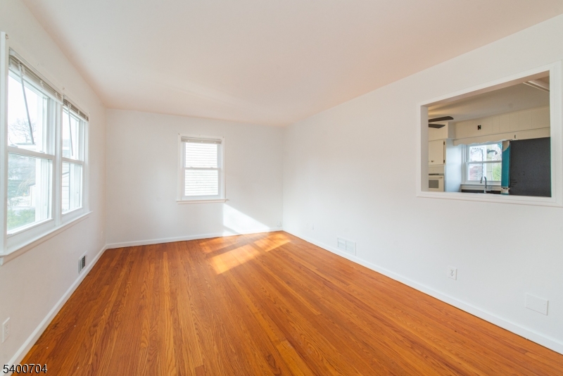 17 Cedar Street Bloomfield, NJ 07003 - Photo 11 of 21 a view of an empty room with wooden floor and a window