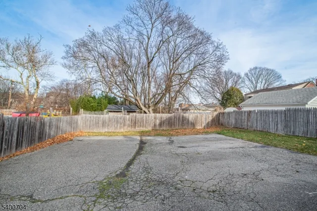 a view of backyard with wooden fence