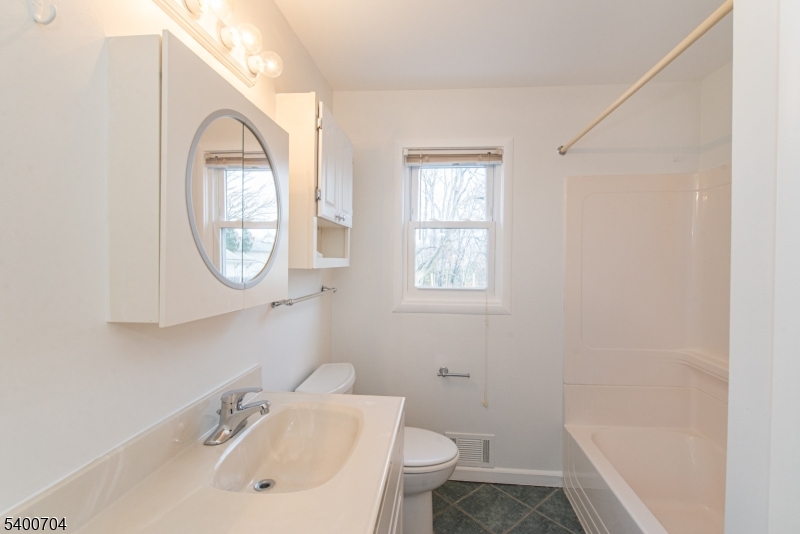 17 Cedar Street Bloomfield, NJ 07003 - Photo 4 of 21 a bathroom with a sink and a mirror