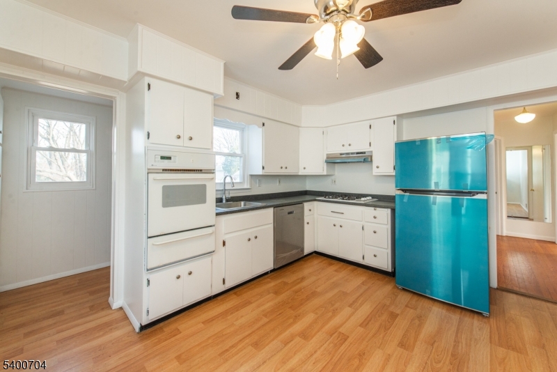 17 Cedar Street Bloomfield, NJ 07003 - Photo 6 of 21 a kitchen with white cabinets and white appliances