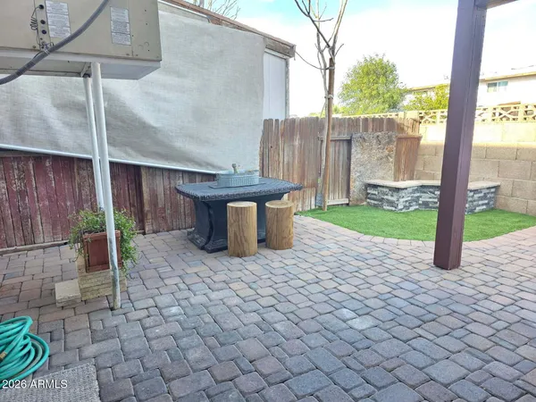 a view of a backyard with plants and outdoor seating
