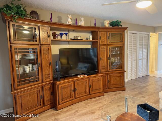 2727 North Wickham Road, Unit 20510 Melbourne, FL 32935 - Photo 11 of 25 a living room with stainless steel appliances furniture and flat screen tv